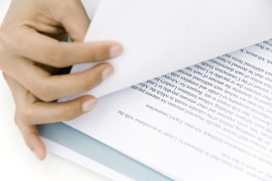 Hand turning document page, close-up